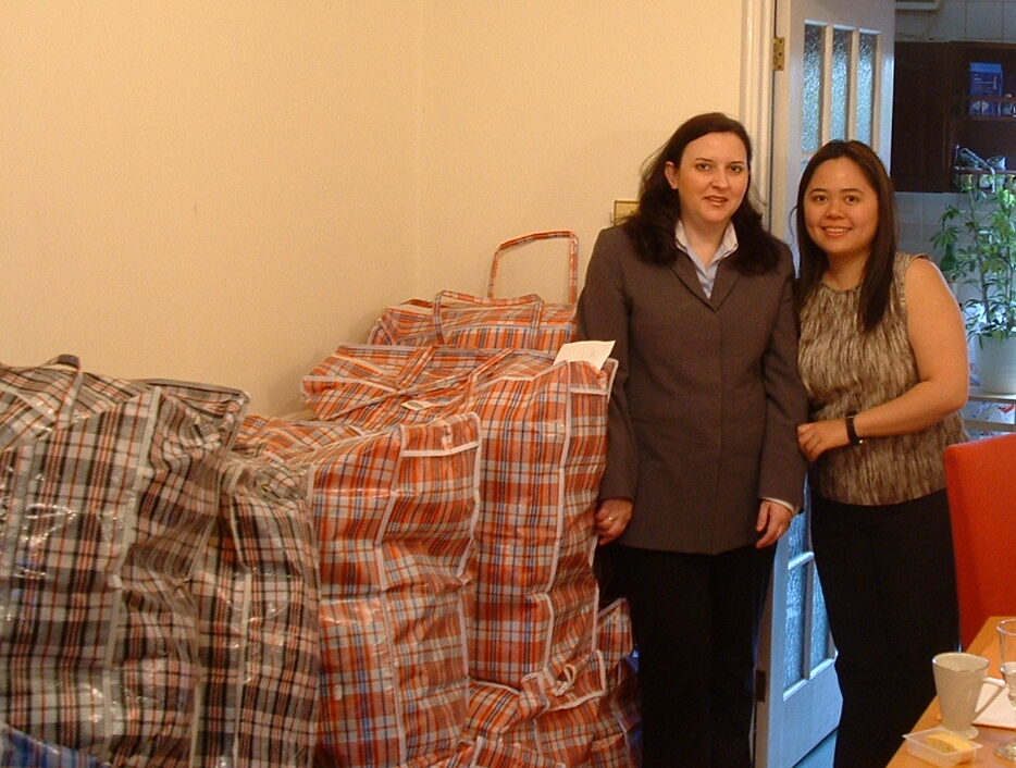 Eileen and Angela by bags of presents for Africa
