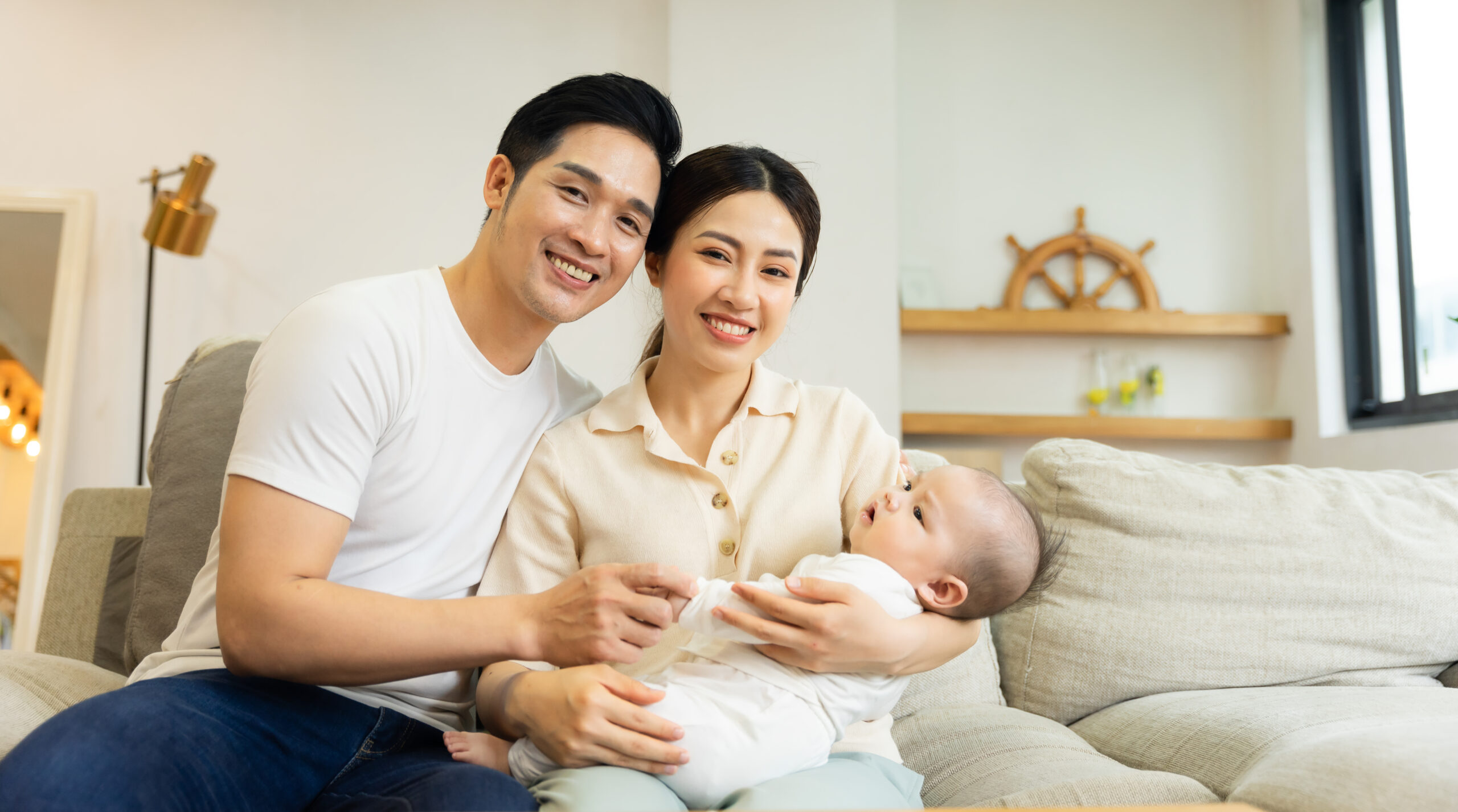 Smiling mother and father holding newborn son at home > Rising Dragon Feng Shui