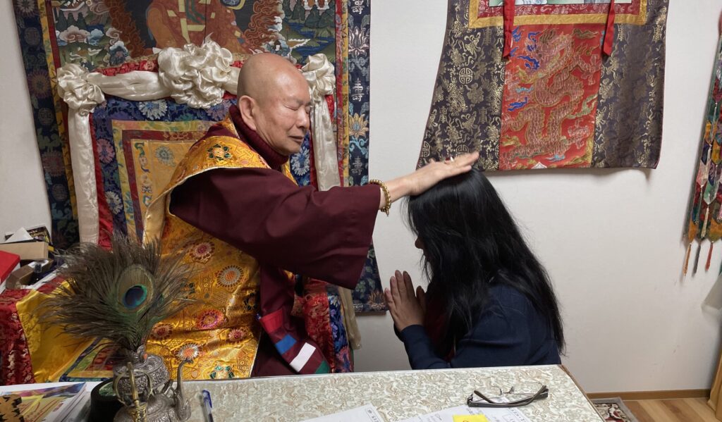 Master Ang receives a blessing empowerment from her teacher, His Holiness Living Buddha Lian Sheng, directly